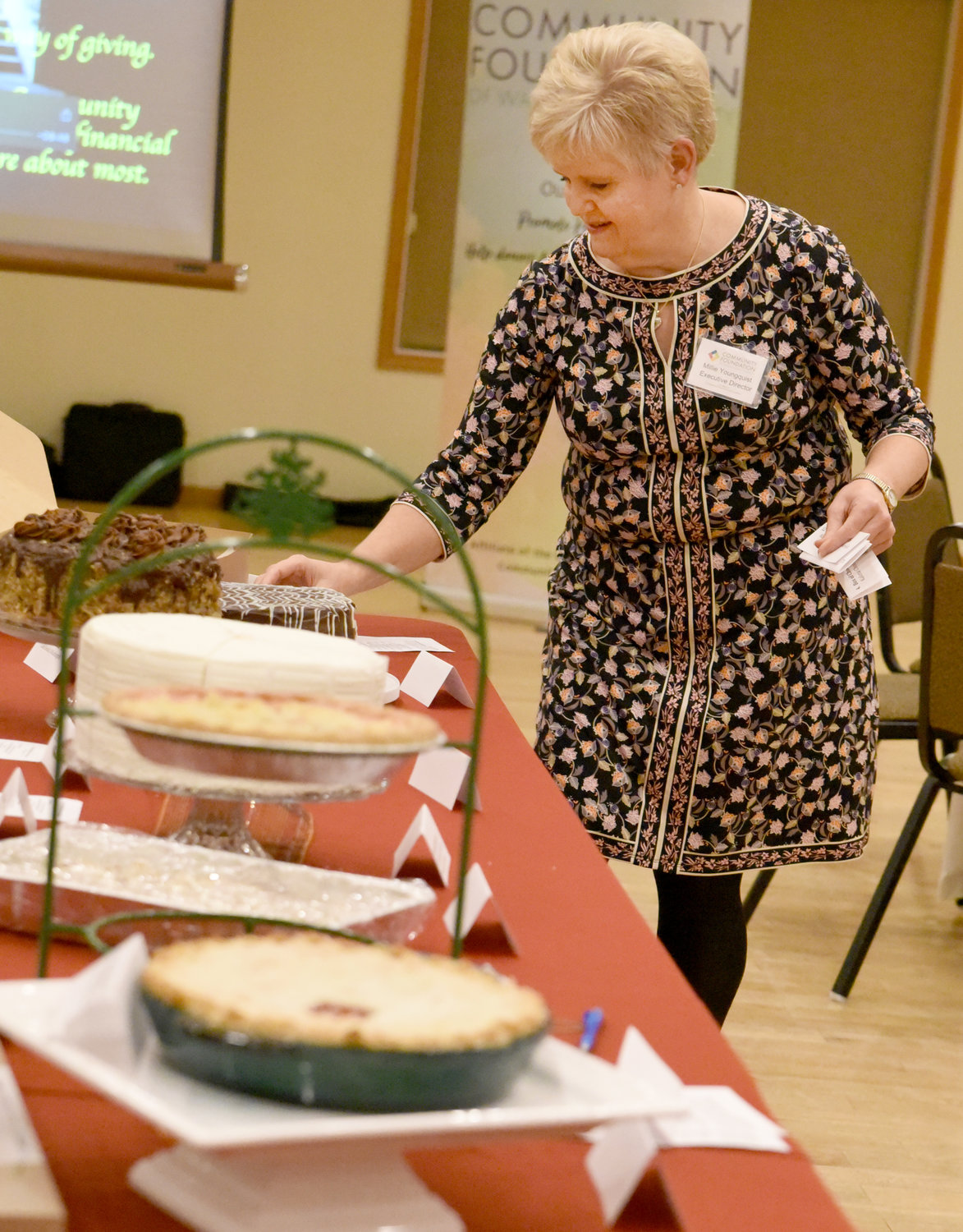 Washington County Community Foundation Executive Director Millie Youngquist labels the many beautiful desserts for the auction, benefitting the foundation and the Kalona Historical Village, at the dinner on Nov. 4.